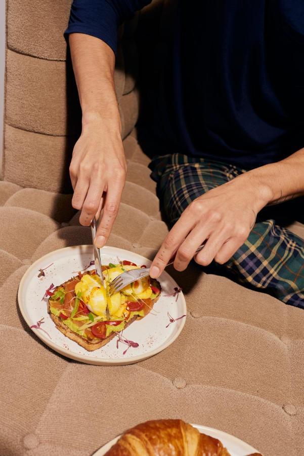 Sanderson Лондон Екстериор снимка A person using a knife and fork to cut food